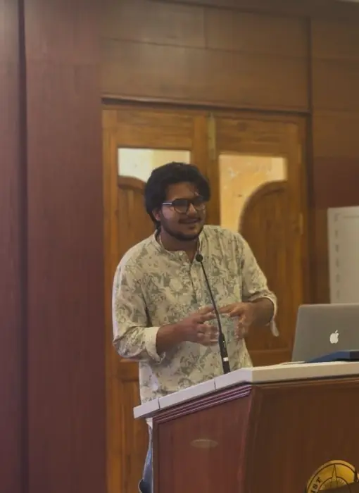Utkarsh speaking at a podium